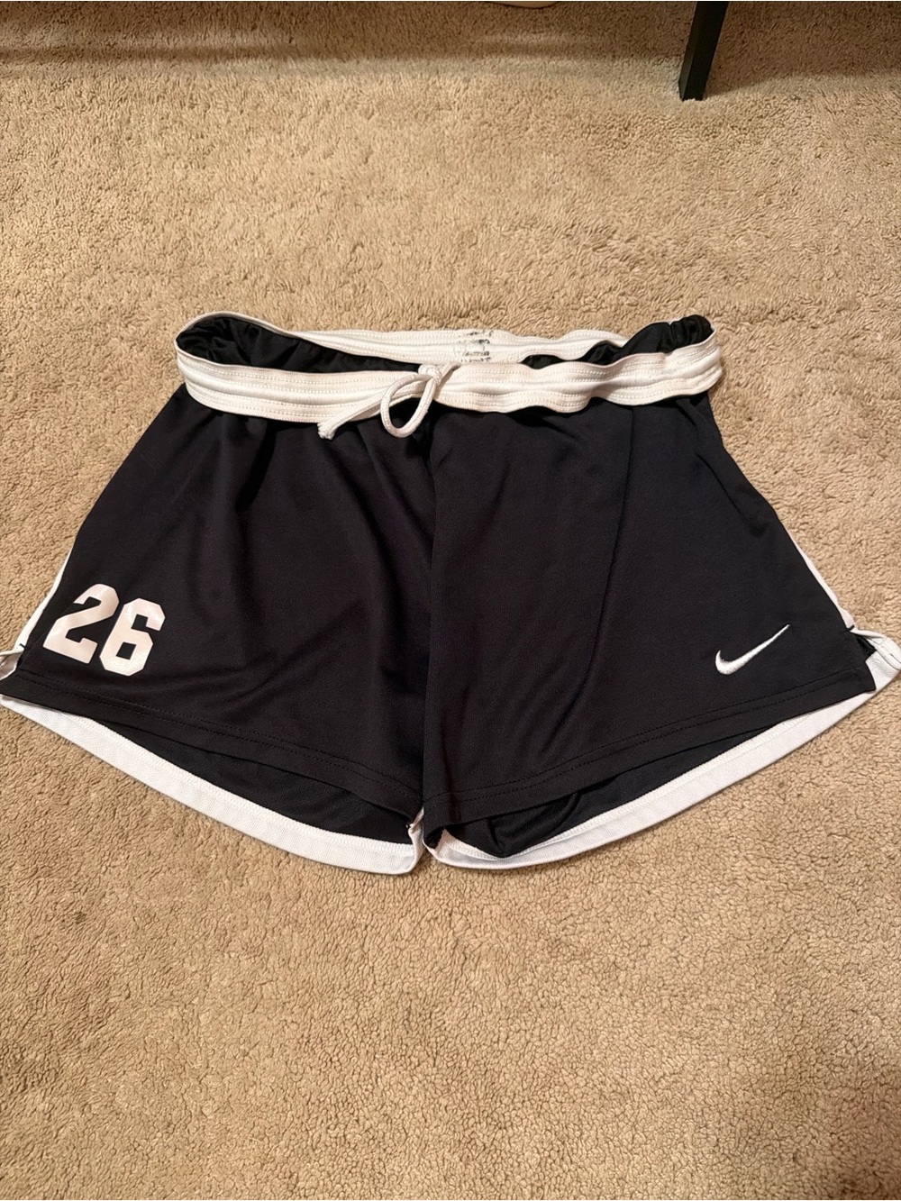 Nike black & white shorts with white number 26. Size medium.